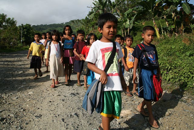 Filipino children walk to school