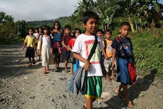 Filipino children walk to school