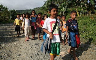 Filipino children walk to school