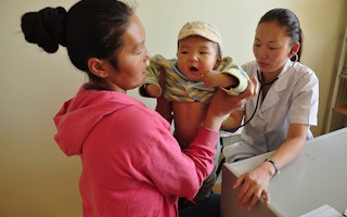 Doctors and other health workers serve a steady stream of patients in a modern clinic in Zuunmod town