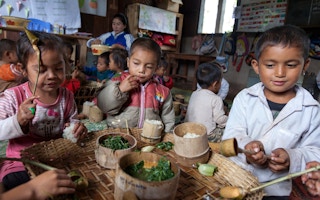 Children in Laos eating traditional foods