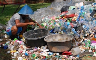 A collector sifts through plastic waste in Indonesia