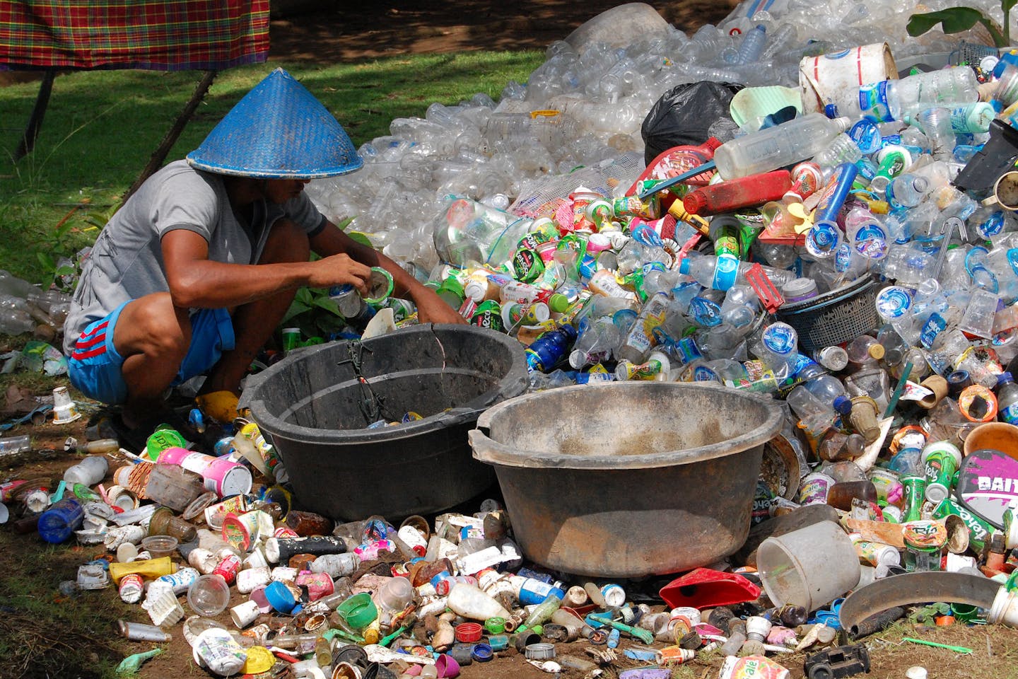 A collector sifts through plastic waste in Indonesia
