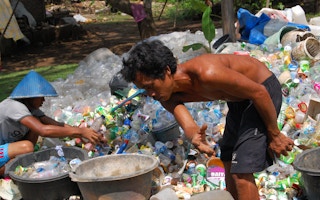man sorts plastic waste