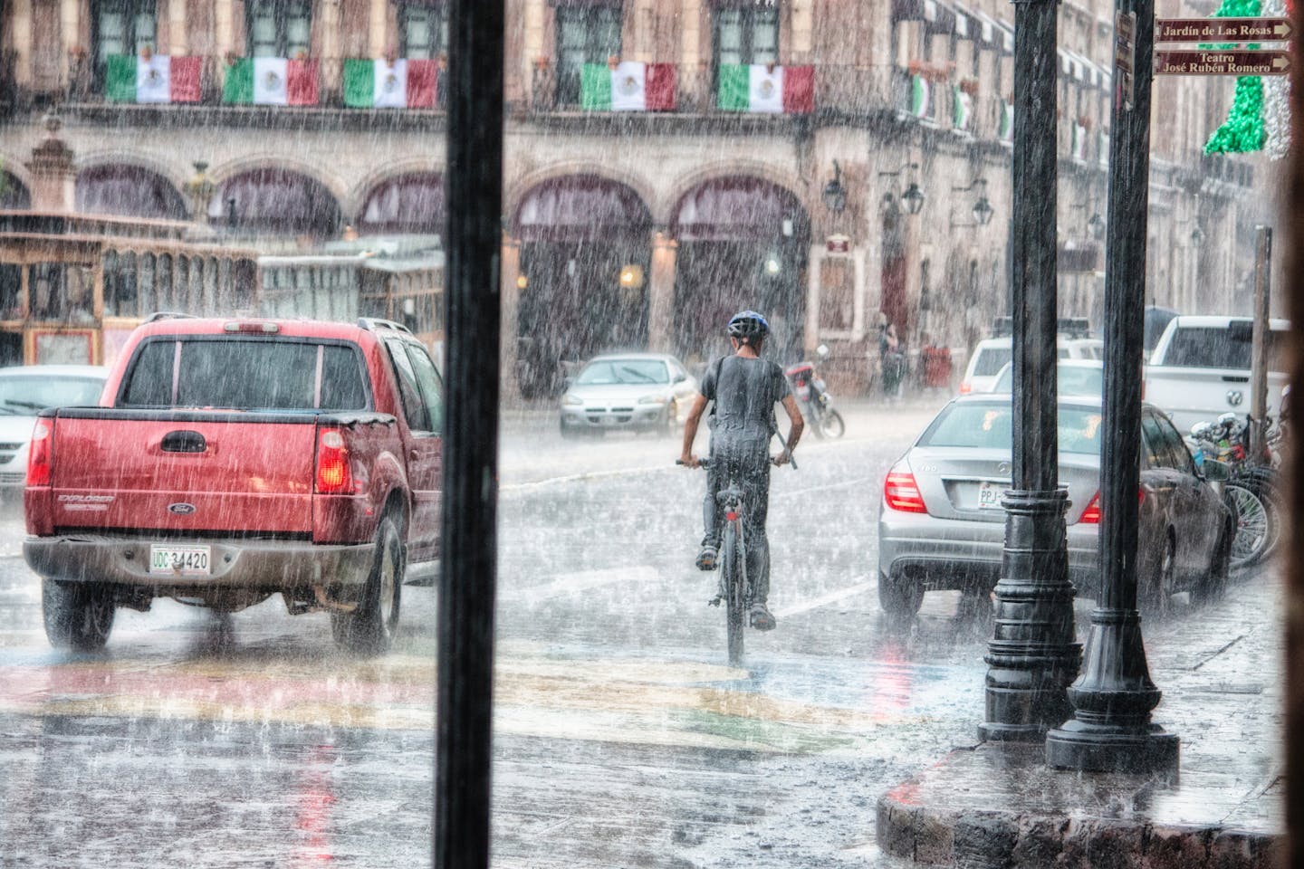 boy riding bike in the rain