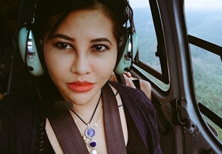 Aida Greenbury riding in a helicopter