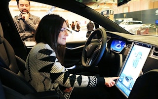 woman on Tesla car