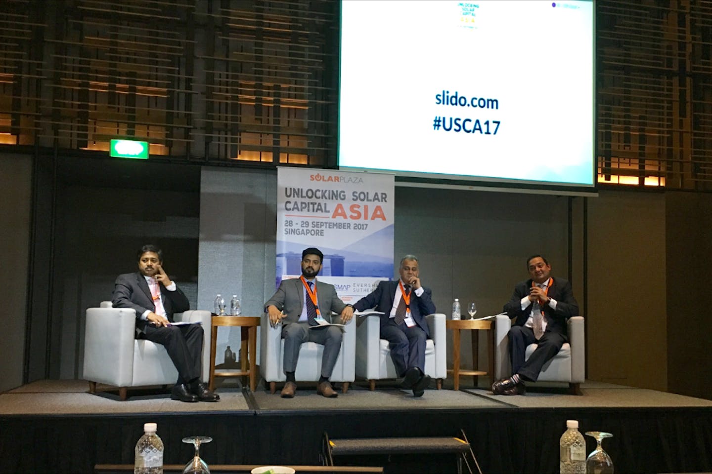 Subrata Barman (far left) of International Finance Corporation fields a heated question from the audience about the criteria for awarding loans at Unlocking Solar Capital Asia. Image: Eco-Business