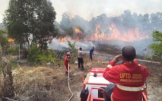 Indonesian firefighters try to control fire