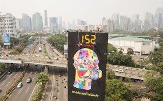Greenpeace activists hang clean air campaign billboard in 