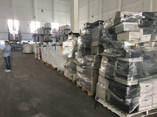 A stack of printers at e-waste recycling facility Virogreen. SMEs find it hard to recycle bulky used electronics, so they are either stored in offices or dumped. Image: Eco-Business