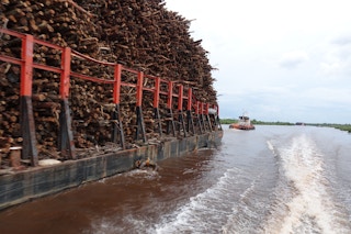 Log barge on Musi River, OKI mill. Image: Eco-Business