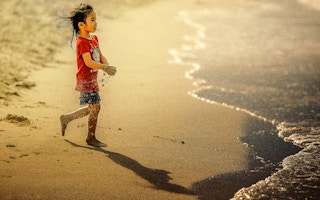 girl rushes to ocean
