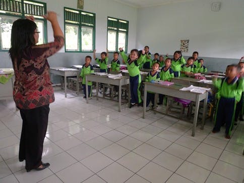 Elementary students at one of the two schools on the plantation sing to welcome visitors.