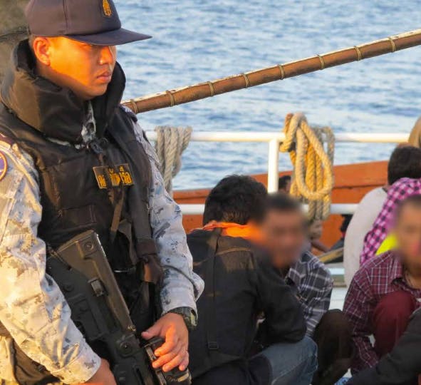 Representatives from the Command Center for Combating Illegal Fishing (CCCIF) inter-agency taskforce inspect a Thai trawler returning from the Saya de Malha Bank.