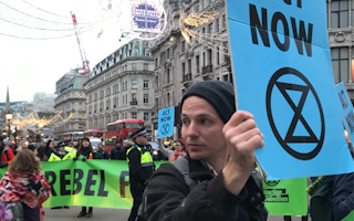 An Extinction Rebellion protester on Oxford Street, one of Britain's busiest shopping districts, demanding immediate government action to reverse climate-toxic policies. Image: Graham Pleasants