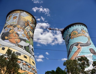  the cooling towers of the retired Orlando coal plant in South Africa. The towers now display large murals and advertisements as well as being used as a platform for bungee and BASE jumping