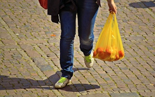 woman carrying plastic bag