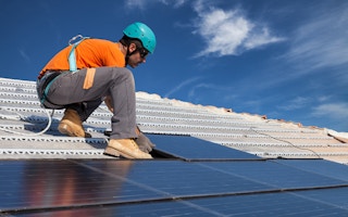 technician solar panels rooftop