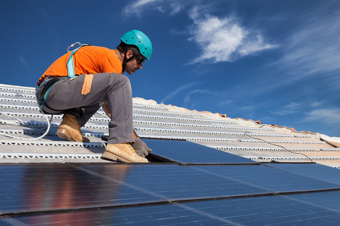 technician solar panels rooftop