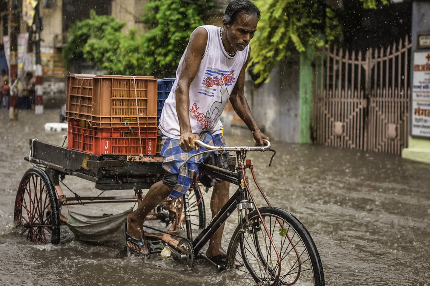 man cycles floodwater