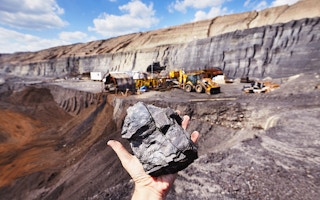 miner holds coal 