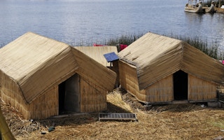 reed hut with solar panels peru
