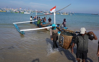 fishermen carry baskets in Indonesia