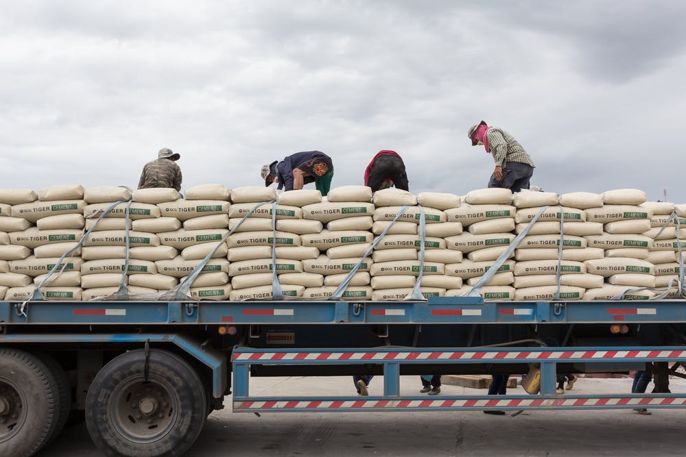 men hauling cement