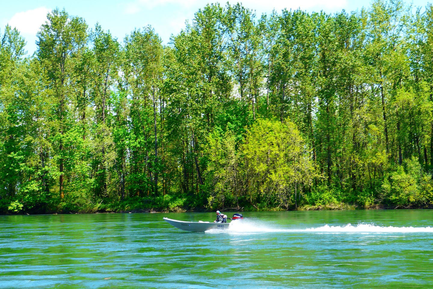 A speedboat cruises down a waterway in the Marshall Islands