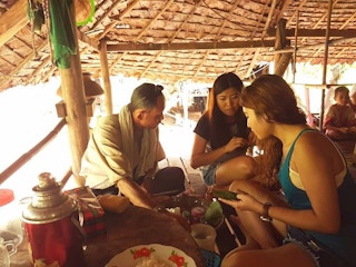 Tourists taste betel nut in a village in Southeast Asia