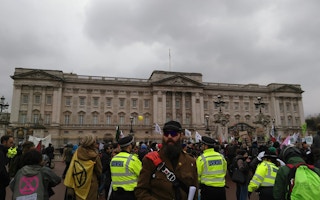 Protesters gather outside Buckingham Palace to protest against the British government's failure to take action to halt dangerous climate change. Image: Kevin Wing